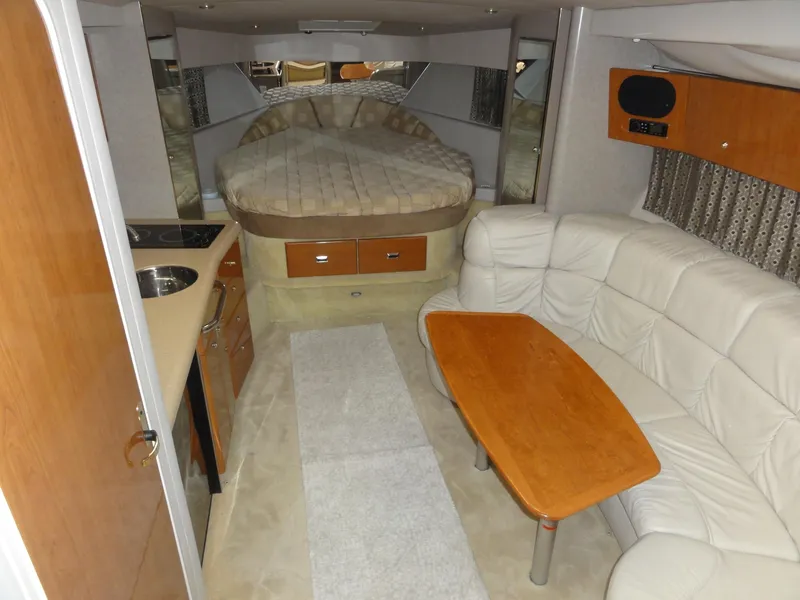 Slide: The Image of Interior of a 2004 Formula 37 PC yacht with bed, kitchenette, and seating area. - 25