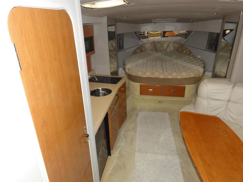 Slide: The Image of Interior of 2004 Formula 37 PC yacht with bed, kitchenette, and seating area. - 26