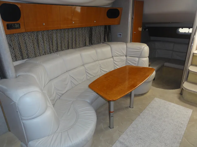 Slide: The Image of 2004 Formula 37 PC yacht interior with white leather seating and wooden table. - 28