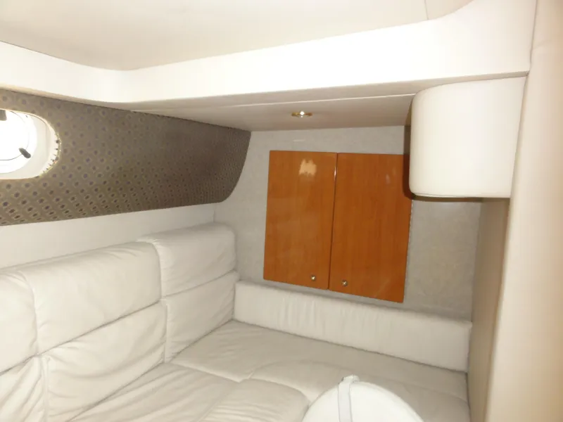 Slide: The Image of 2004 Formula 37 PC cabin interior with white seating and wooden cabinets. - 32