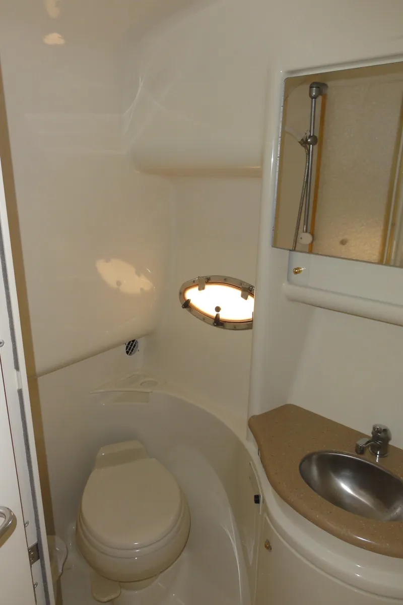 Slide: The Image of 2004 Formula 37 PC yacht bathroom with toilet, sink, and porthole window. - 36
