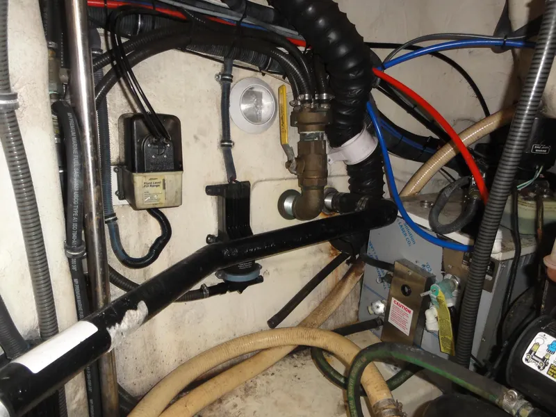 Slide: The Image of Engine compartment of a 2004 Formula 37 PC boat, showing various hoses and components. - 44