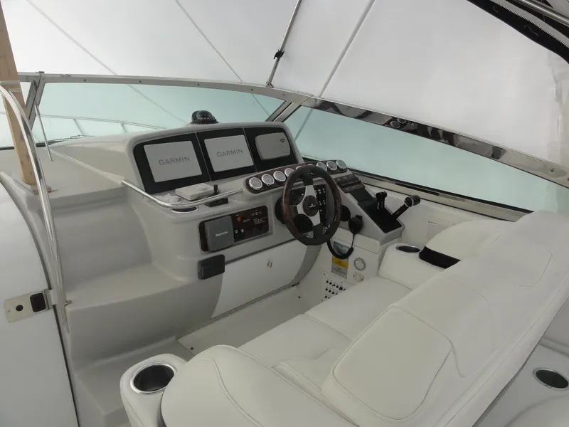 Slide: The Image of 2004 Formula 37 PC yacht cockpit with Garmin navigation displays and white seating. - 6