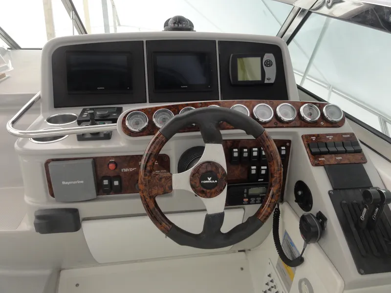 Slide: The Image of 2004 Formula 37 PC yacht dashboard with steering wheel, gauges, and navigation controls. - 7