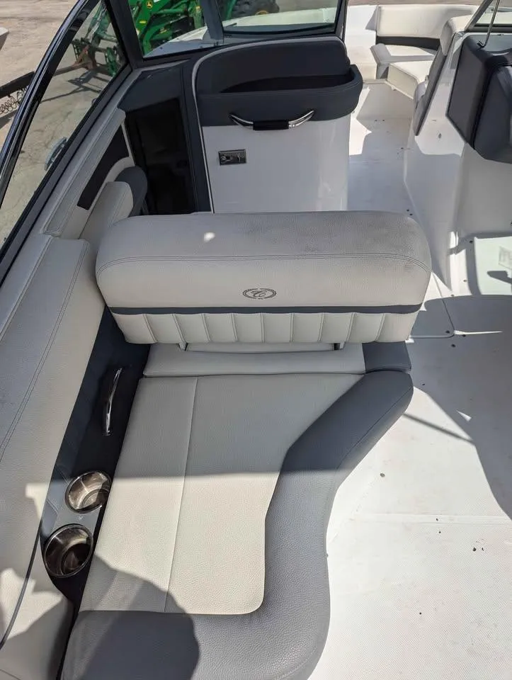 Slide: The Image of 2020 Cobalt 25SC boat interior with white and gray seating, cup holders, and modern design. - 10