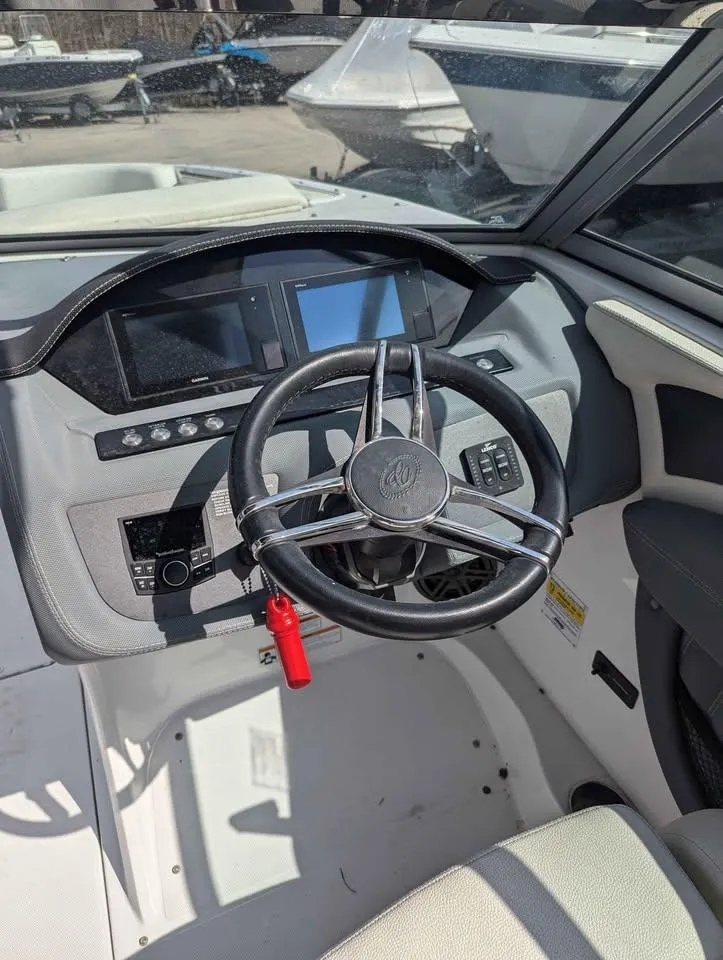 Slide: The Image of 2020 Cobalt 25SC boat dashboard with steering wheel and digital displays. - 12