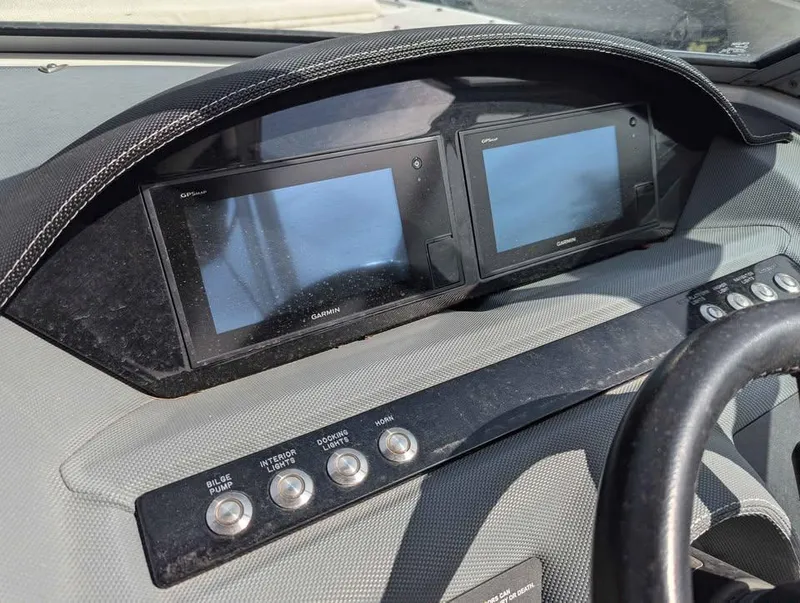 Slide: The Image of 2020 Cobalt 25SC dashboard with dual Garmin displays and control buttons. - 13