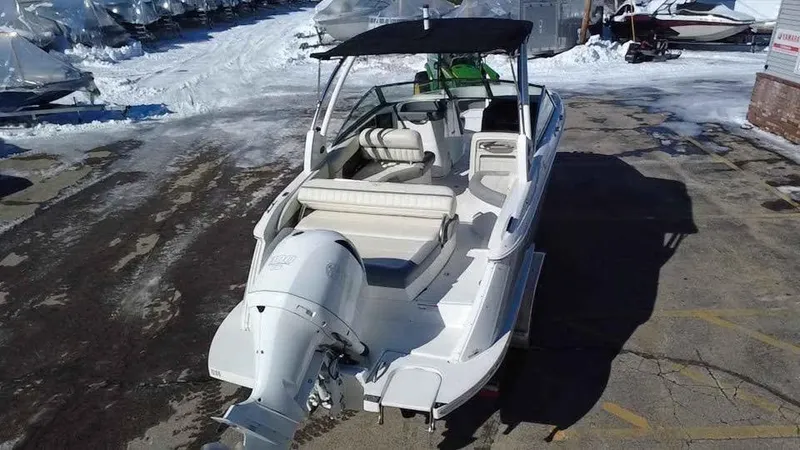 Slide: The Image of 2020 Cobalt 25SC boat with outboard motor, parked on snowy pavement. - 3