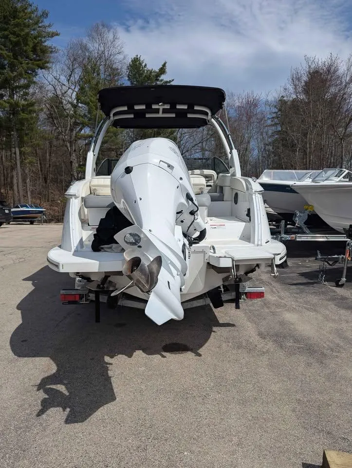 Slide: The Image of 2020 Cobalt 25SC boat with outboard motor, parked outdoors on a sunny day. - 4