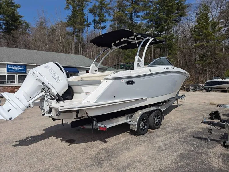 Slide: The Image of 2020 Cobalt 25SC boat on trailer with Yamaha outboard motor, parked outdoors. - 5