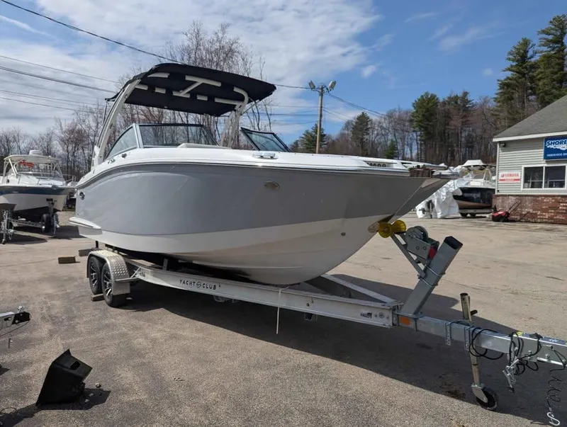 Slide: The Image of 2020 Cobalt 25SC boat on trailer, parked outdoors under a clear sky. - 6