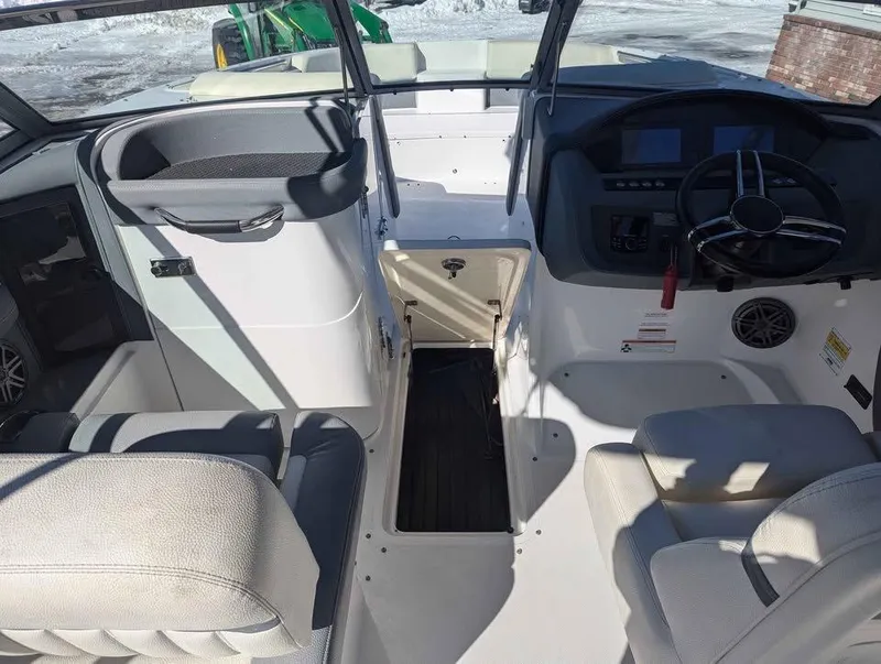 Slide: The Image of 2020 Cobalt 25SC boat interior with steering wheel and seating. - 8