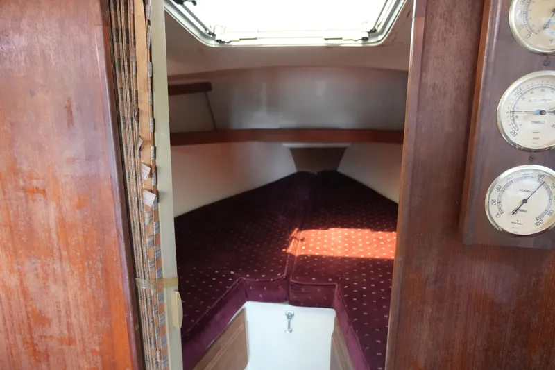 Slide: The Image of Interior cabin of a 1990 Catalina 28 sailboat with maroon upholstery. - 10