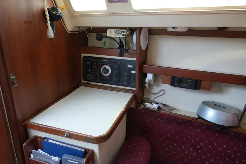 Slide: The Image of Interior of a 1990 Catalina 28 sailboat with navigation station and seating area. - 14