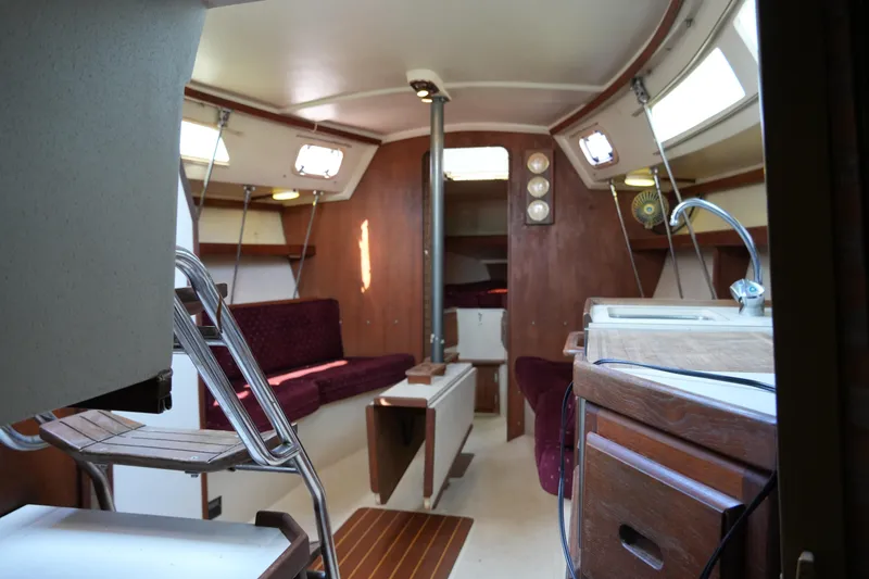 Slide: The Image of Interior of 1990 Catalina 28 sailboat with wood finish and seating area. - 22