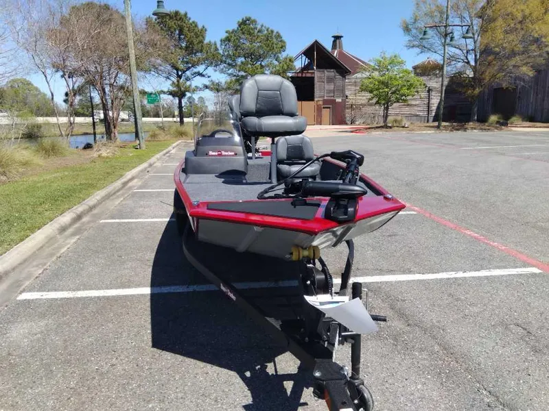 Slide: The Image of 2025 Tracker Bass Tracker Classic XL boat parked in a lot, featuring dual seats and fishing equipment. - 5