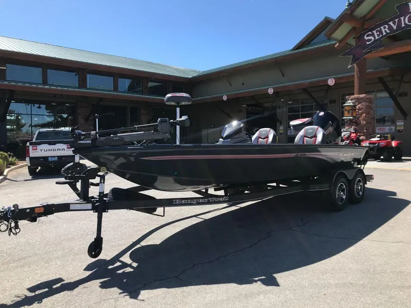Slide: The Image of 2025 Ranger ALPHA 208 boat on trailer outside a service center. - 2