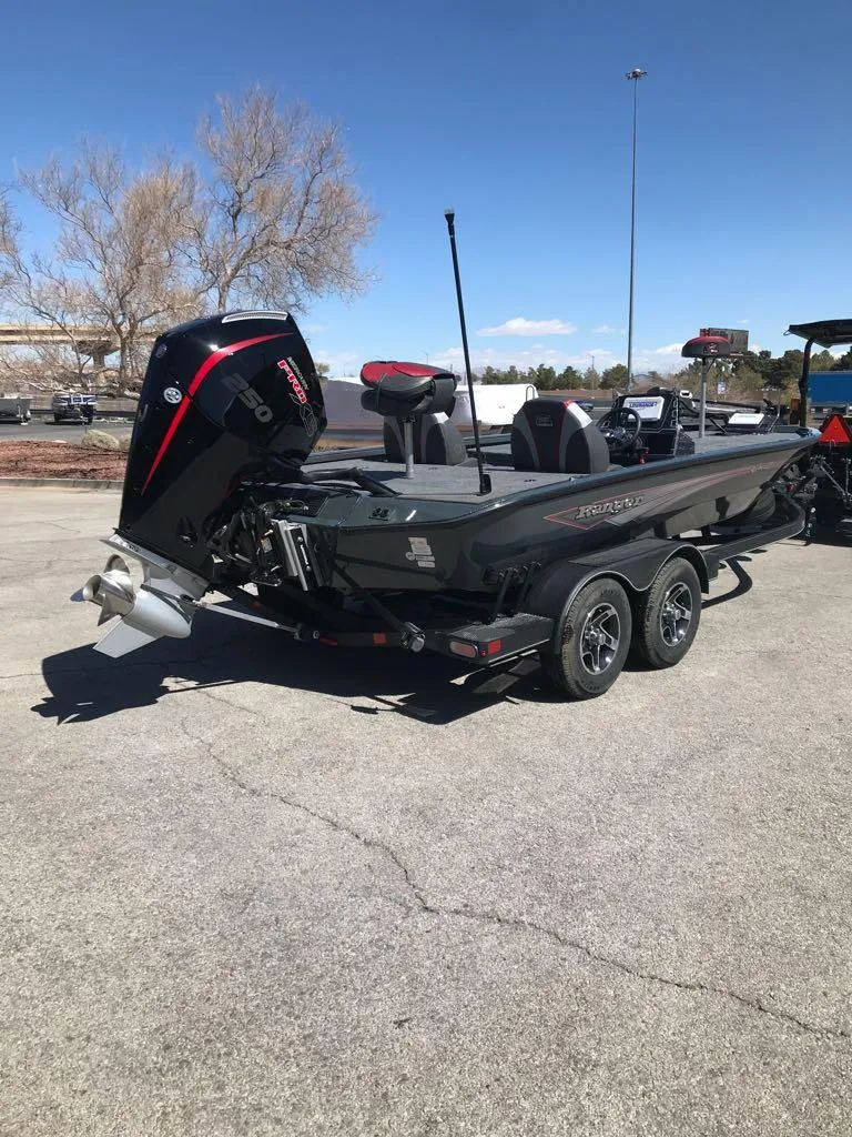 Slide: The Image of 2025 Ranger ALPHA 208 boat with outboard motor on a trailer in a parking lot. - 8