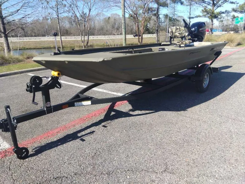 Slide: The Image of 2025 Tracker Grizzly 1654 T Sportsman boat on trailer in parking lot. - 11