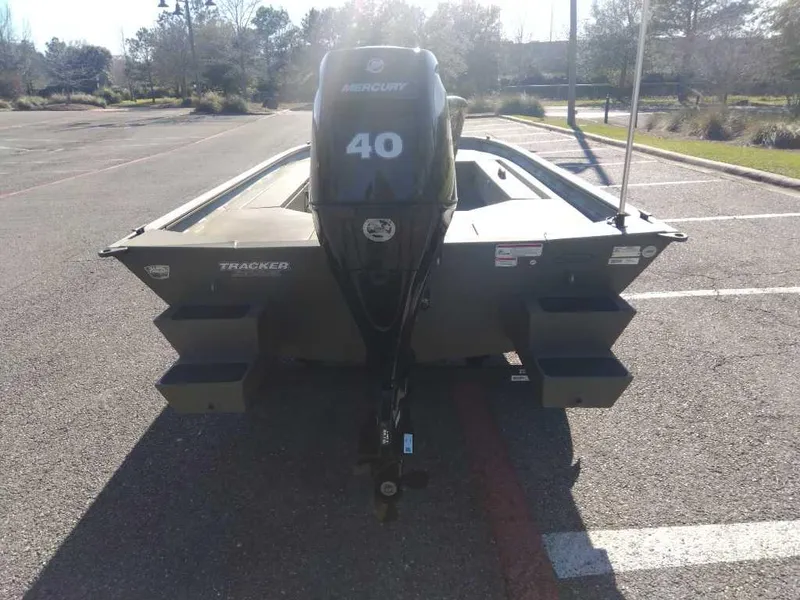 Slide: The Image of 2025 Tracker Grizzly 1654 T Sportsman boat with Mercury 40 outboard motor in parking lot. - 2