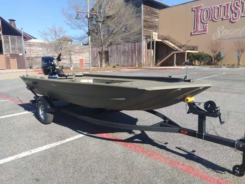 Slide: The Image of 2025 Tracker Grizzly 1654 T Sportsman boat on trailer in parking lot. - 5