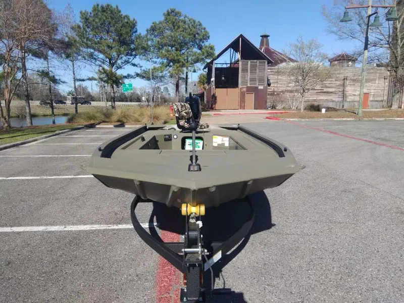 Slide: The Image of 2025 Tracker Grizzly 1654 T Sportsman boat parked outdoors on a sunny day. - 6