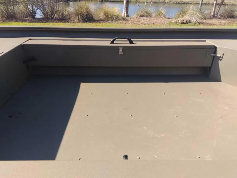 Slide: The Image of 2025 Tracker Grizzly 1654 T Sportsman boat interior with storage compartment. - 8