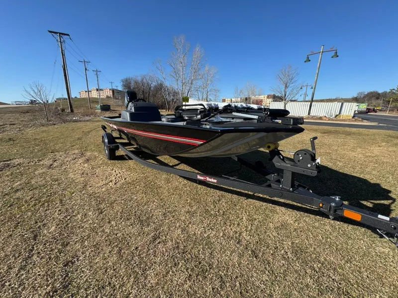 Slide: The Image of 2025 Tracker Bass Tracker Classic XL boat on trailer, parked on grass under clear blue sky. - 4