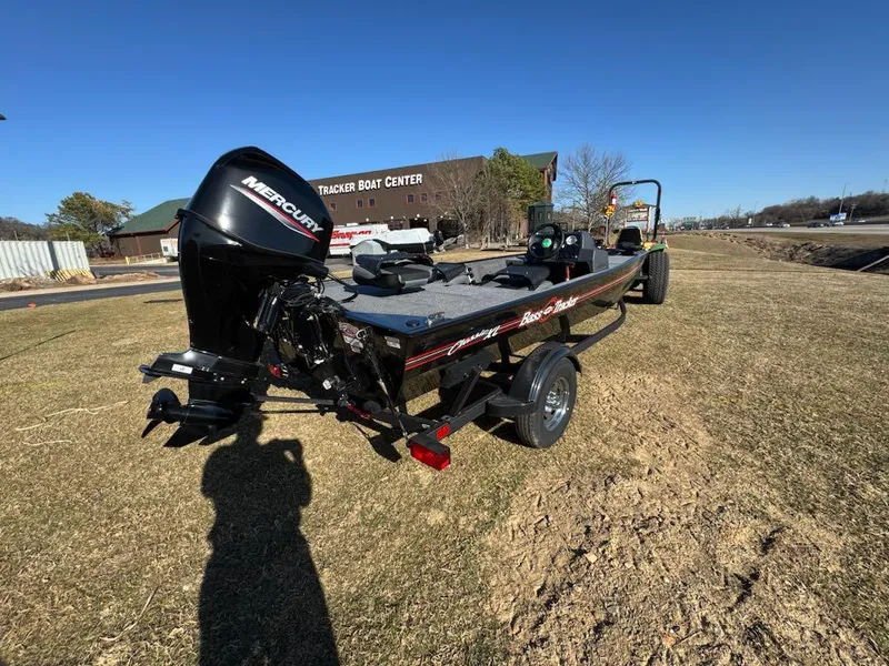 Slide: The Image of 2025 Tracker Bass Tracker Classic XL boat with Mercury engine on grassy area. - 5