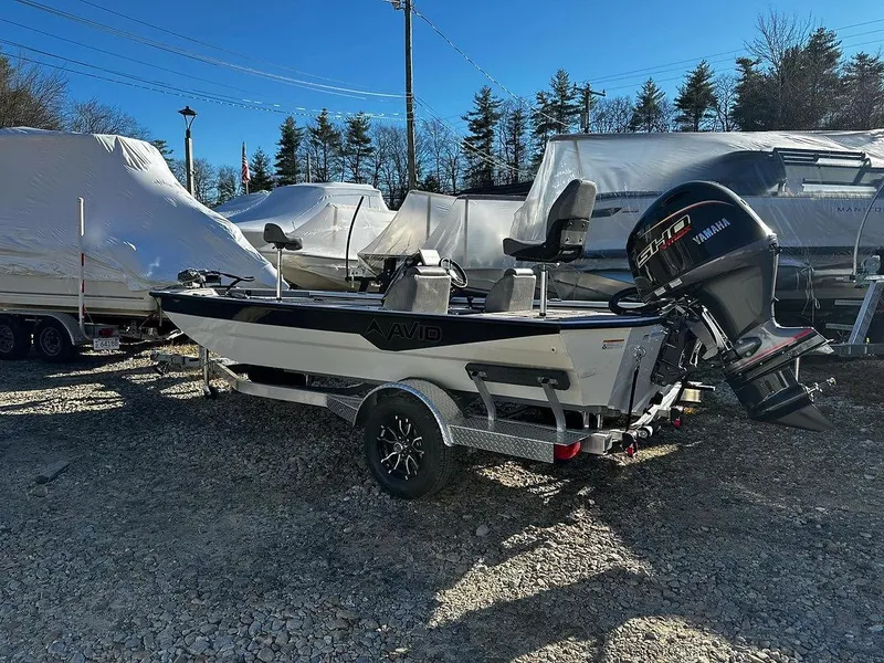 Slide: The Image of 2025 Avid 18 Vertex boat with Yamaha engine on trailer, parked outdoors. - 0