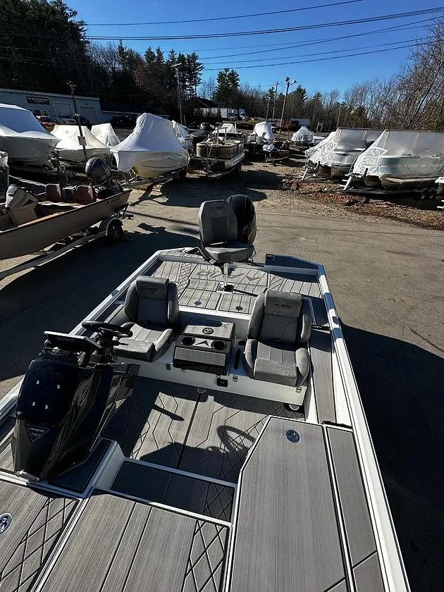 Slide: The Image of 2025 Avid 18 Vertex boat in storage yard, surrounded by covered boats. - 7