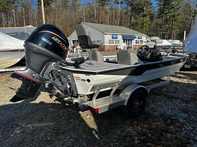 Slide: The Image of Avid 18 Vertex 2025 boat with Yamaha engine on a trailer, parked outdoors. - 8