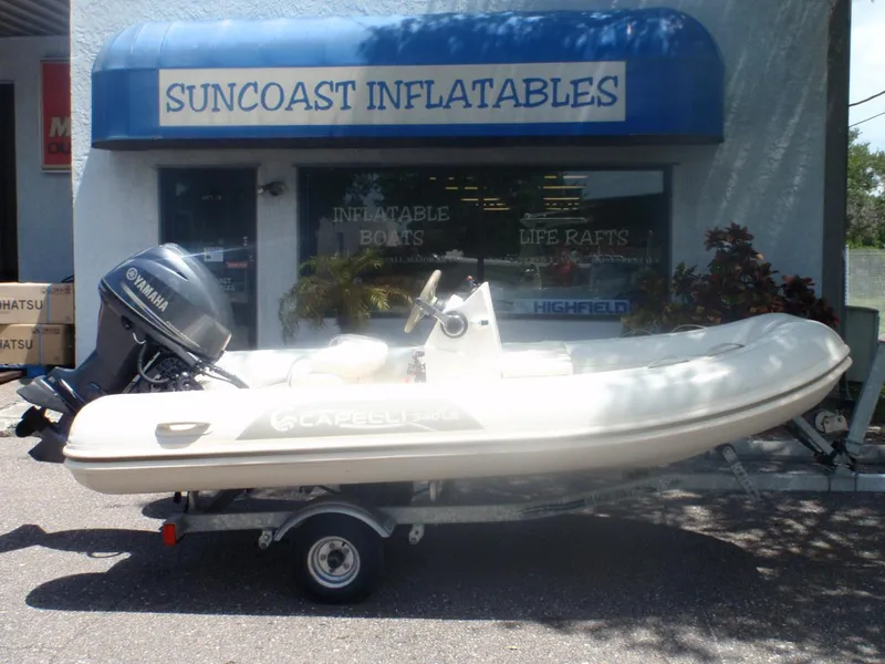 Slide: The Image of 2016 Capelli Tempest 340 LE Tender inflatable boat outside Suncoast Inflatables store. - 0