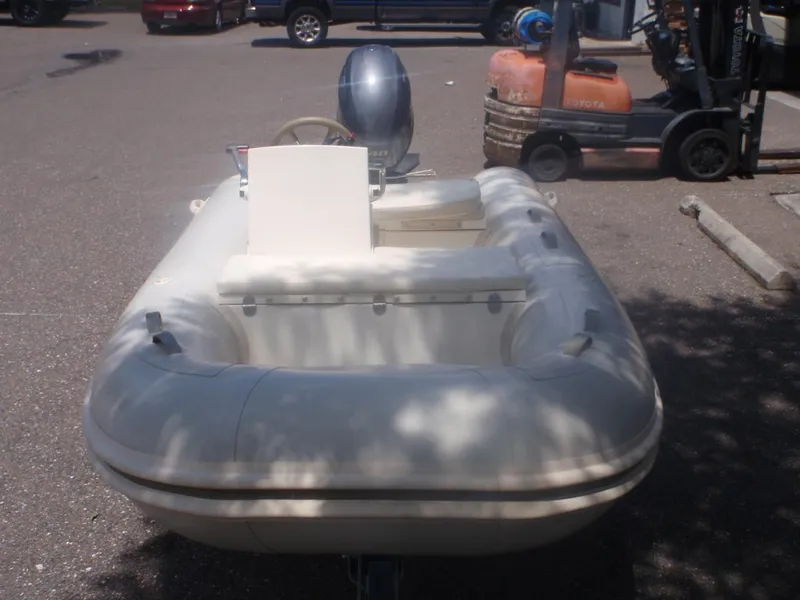 Slide: The Image of 2016 Capelli Tempest 340 LE Tender inflatable boat in a parking lot. - 1