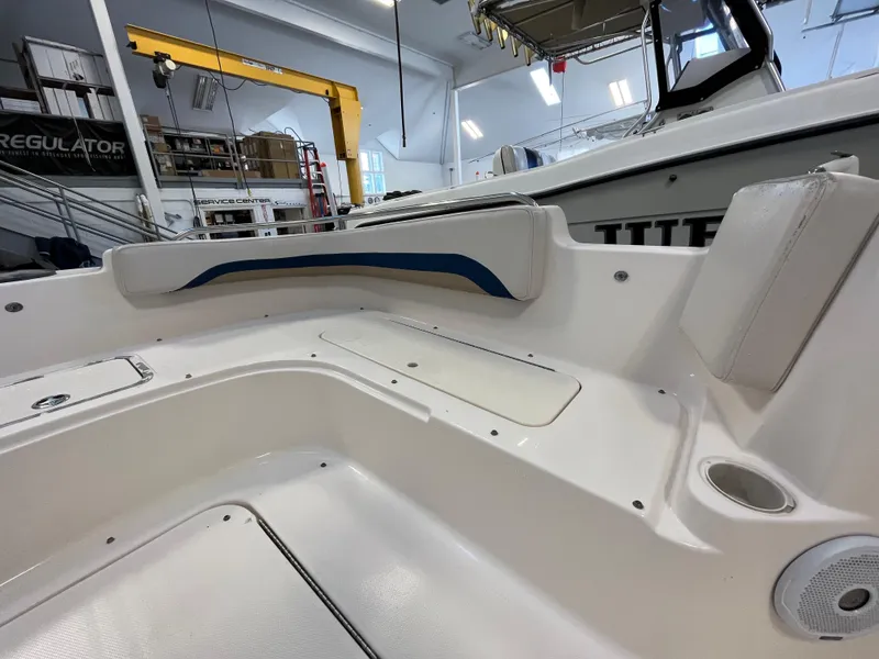 Slide: The Image of Interior view of a 2005 Godfrey FD211 boat, showcasing seating and storage areas. - 10