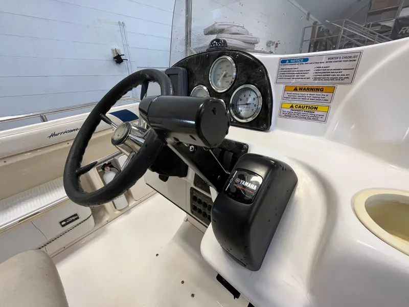 Slide: The Image of 2005 Godfrey FD211 boat dashboard with steering wheel and Yamaha controls. - 17
