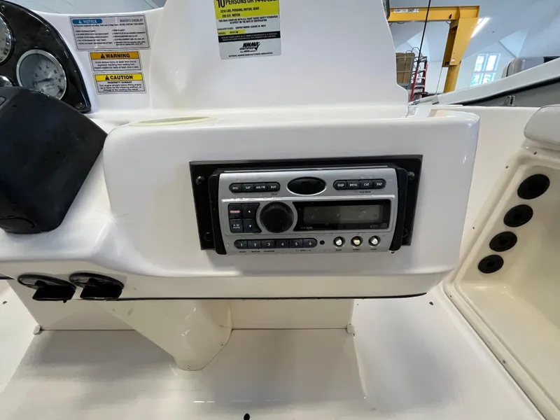 Slide: The Image of Boat dashboard with stereo system, Godfrey FD211, 2005 model, featuring control buttons and display. - 18