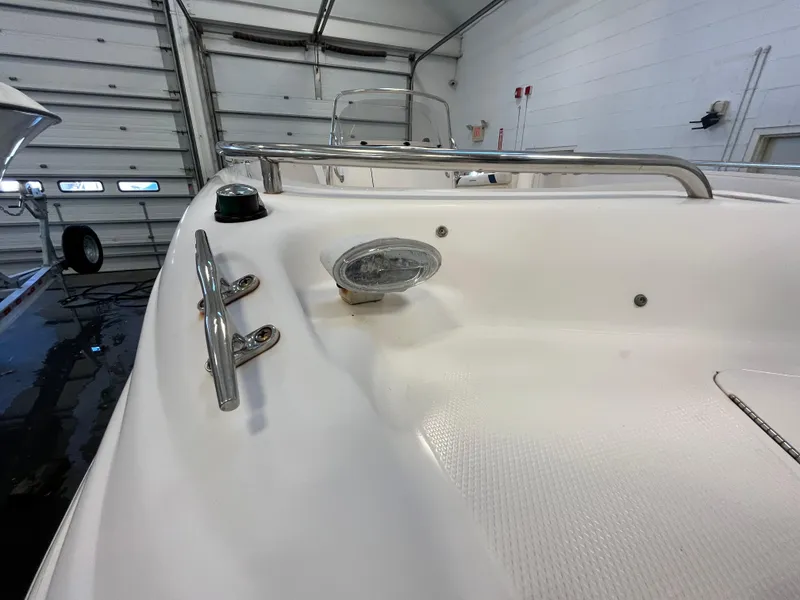 Slide: The Image of 2005 Godfrey FD211 boat interior with stainless steel fittings and light in a garage. - 22