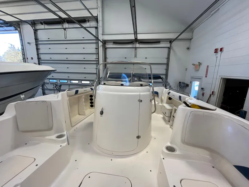 Slide: The Image of 2005 Godfrey FD211 boat interior in a garage, showcasing seating and helm. - 23