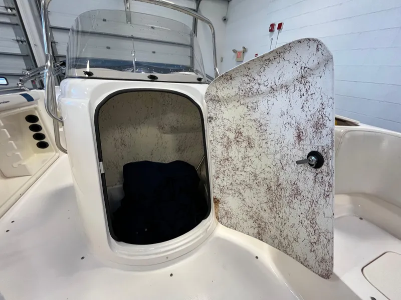 Slide: The Image of 2005 Godfrey FD211 boat storage compartment with open door in a garage setting. - 24