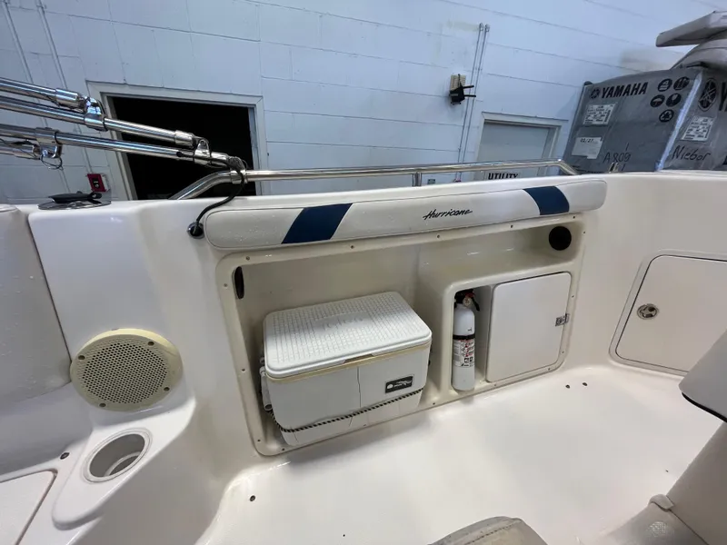 Slide: The Image of Interior of a 2005 Godfrey FD211 boat with storage compartments and safety equipment. - 28
