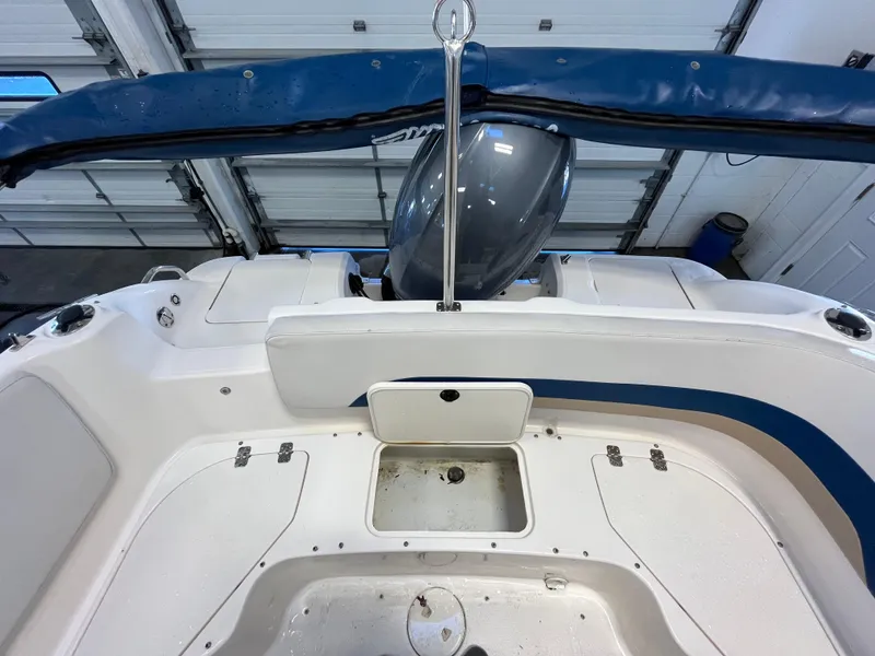 Slide: The Image of 2005 Godfrey FD211 boat interior with motor, blue accents, and storage compartments. - 30