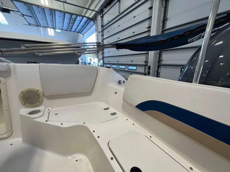 Slide: The Image of Interior view of a 2005 Godfrey FD211 boat, showcasing seating and storage areas. - 32
