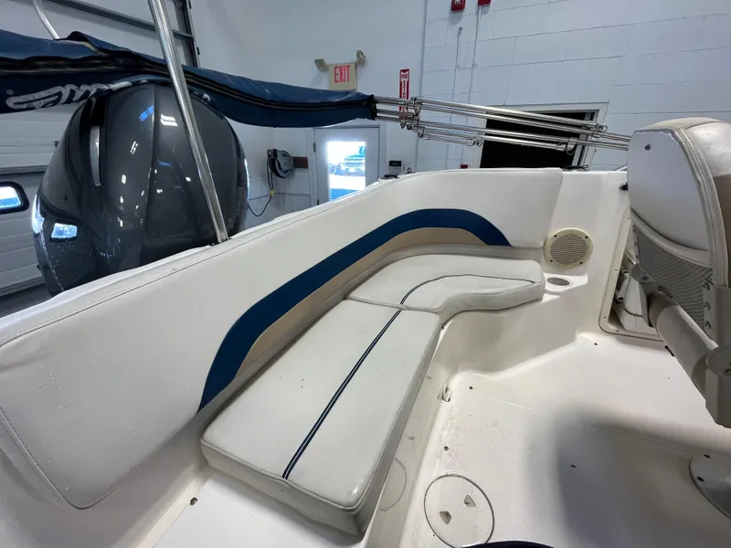 Slide: The Image of Interior of a 2005 Godfrey FD211 boat with white and blue seating. - 39