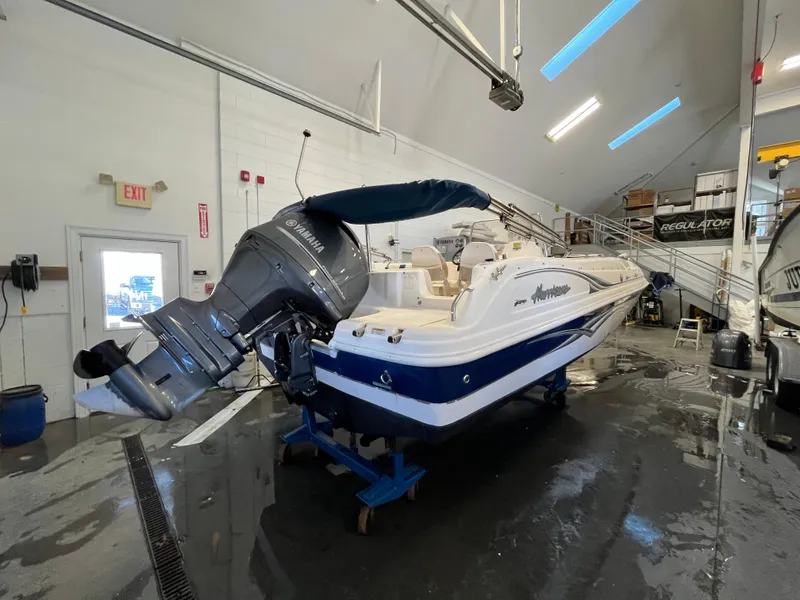 Slide: The Image of 2005 Godfrey FD211 boat in a garage with Yamaha outboard motor. - 4