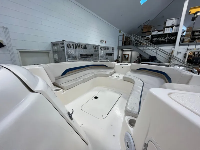 Slide: The Image of 2005 Godfrey FD211 boat interior with spacious seating in a showroom. - 41