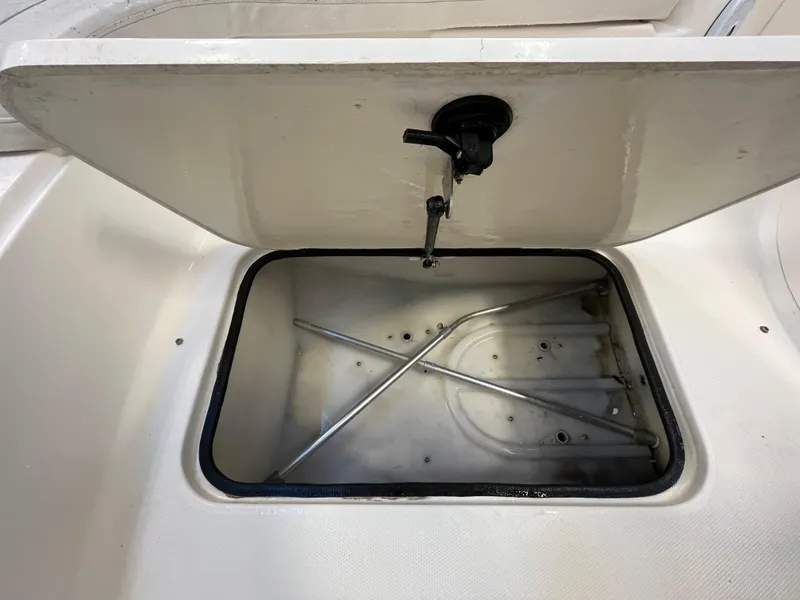 Slide: The Image of Open storage compartment on a 2005 Godfrey FD211 boat, showing interior details. - 43