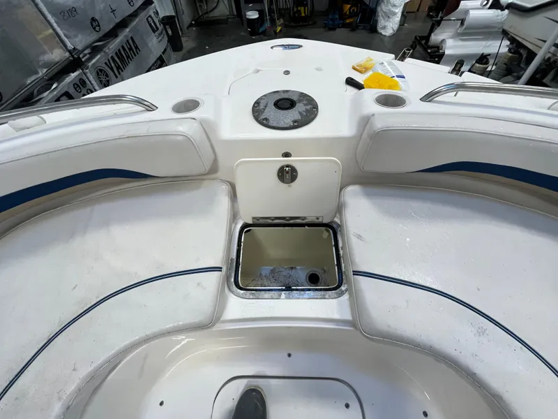 Slide: The Image of Bow seating area of a 2005 Godfrey FD211 boat with storage compartment. - 44