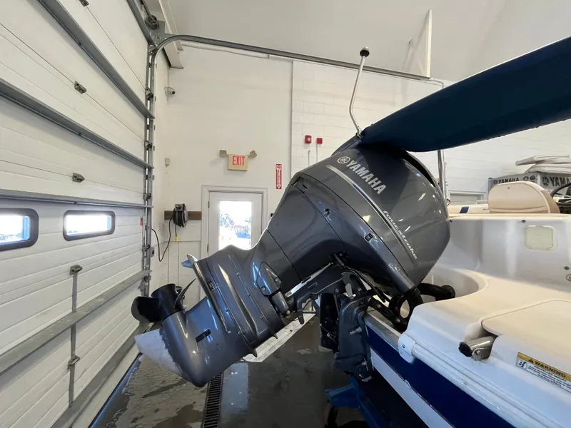 Slide: The Image of 2005 Godfrey FD211 boat with Yamaha outboard motor in a garage setting. - 5