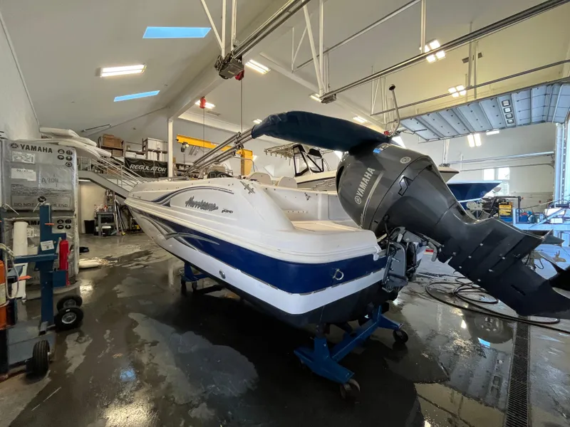 Slide: The Image of 2005 Godfrey FD211 boat in a workshop with Yamaha engine, on a stand. - 7